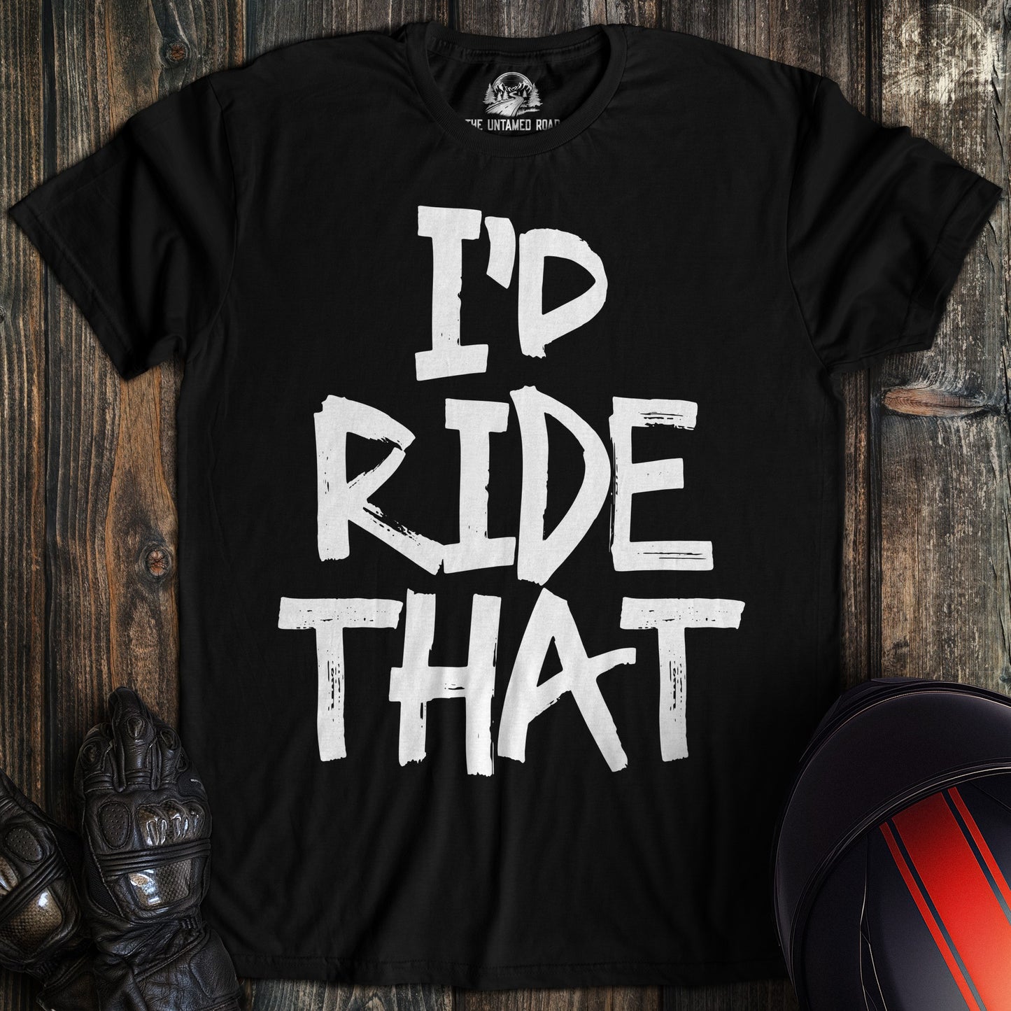 A black t-shirt featuring the funny biker phrase "I'D RIDE THAT" in large, white distressed paint-style lettering.