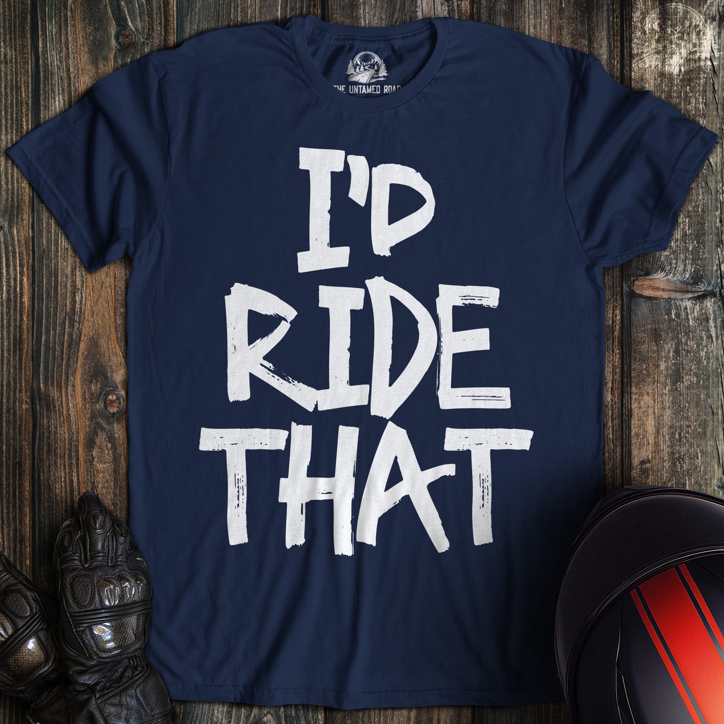 A navy blue t-shirt featuring the funny biker phrase "I'D RIDE THAT" in a white, distressed paint-style font.