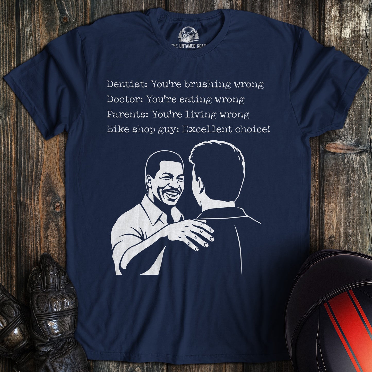 A navy blue t-shirt featuring a funny biker graphic and text about a bike shop guy saying, "Excellent choice!"