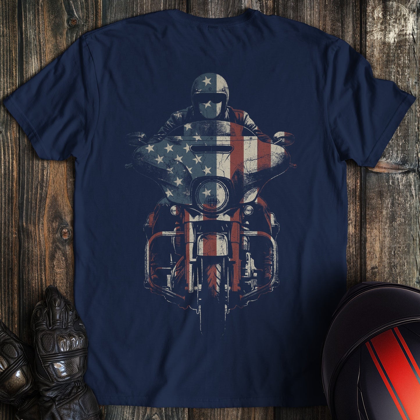 A navy blue crew neck t-shirt featuring a graphic of a biker on a motorcycle with an American flag overlay.