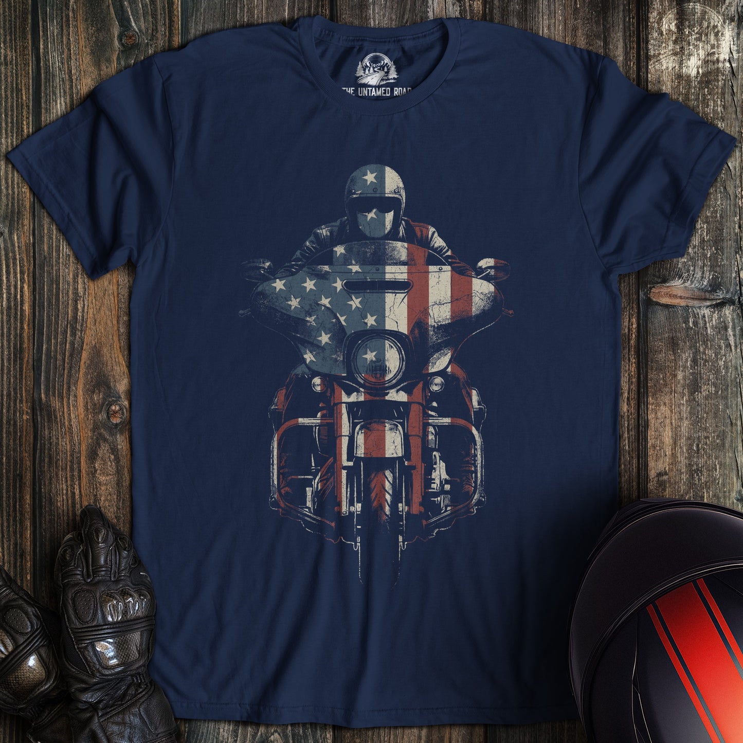 A navy blue crew neck t-shirt featuring a graphic of a biker on a motorcycle with an American flag overlay.