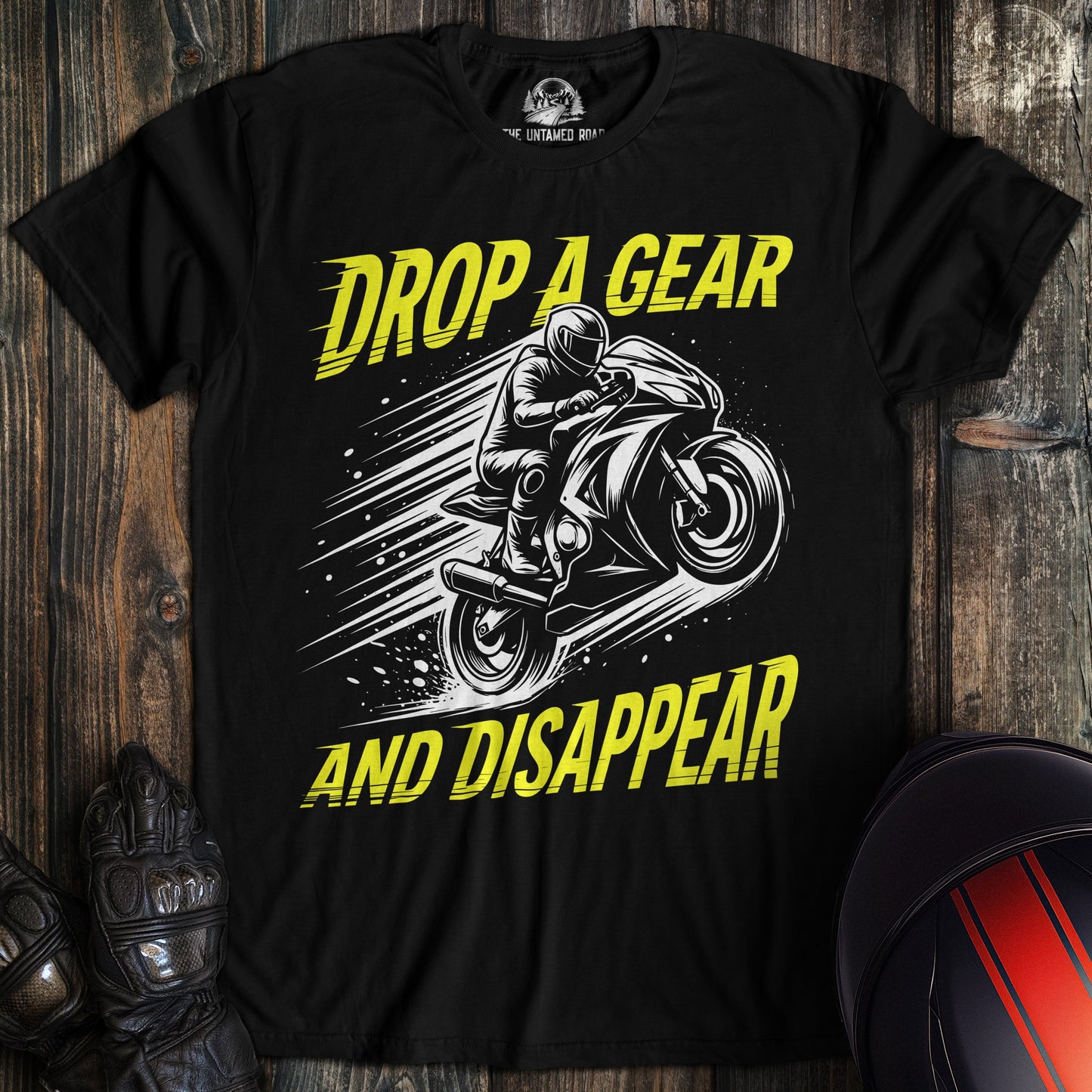 A black t-shirt featuring a motorcycle graphic and the yellow text Drop A Gear And Disappear.