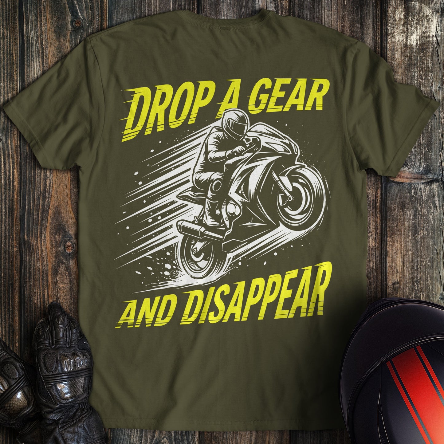 A military green t-shirt featuring a biker on a motorcycle with the text Drop A Gear And Disappear.