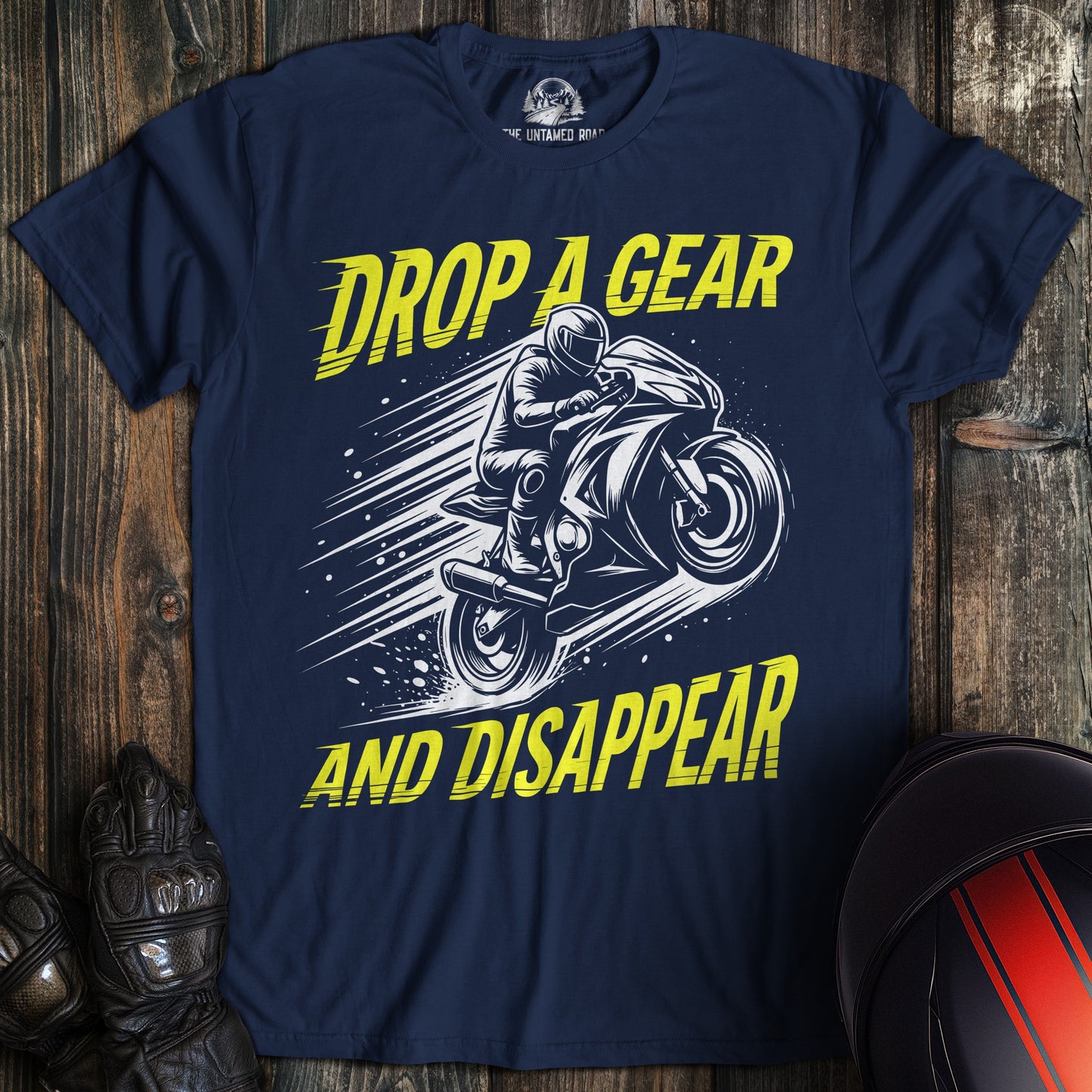 A navy blue t-shirt featuring a motorcycle graphic with the text Drop A Gear And Disappear in yellow.