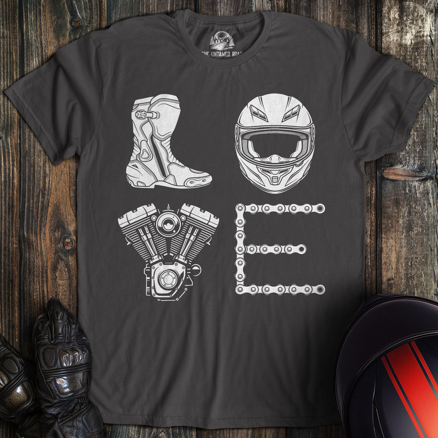Charcoal gray biker t-shirt with the word LOVE spelled using a motorcycle boot, helmet, engine, and chain.