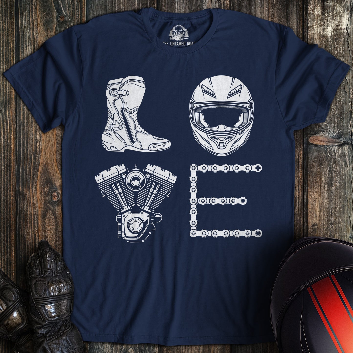 Navy blue t-shirt with white motorcycle gear graphics spelling LOVE using a boot, helmet, engine, and chain.