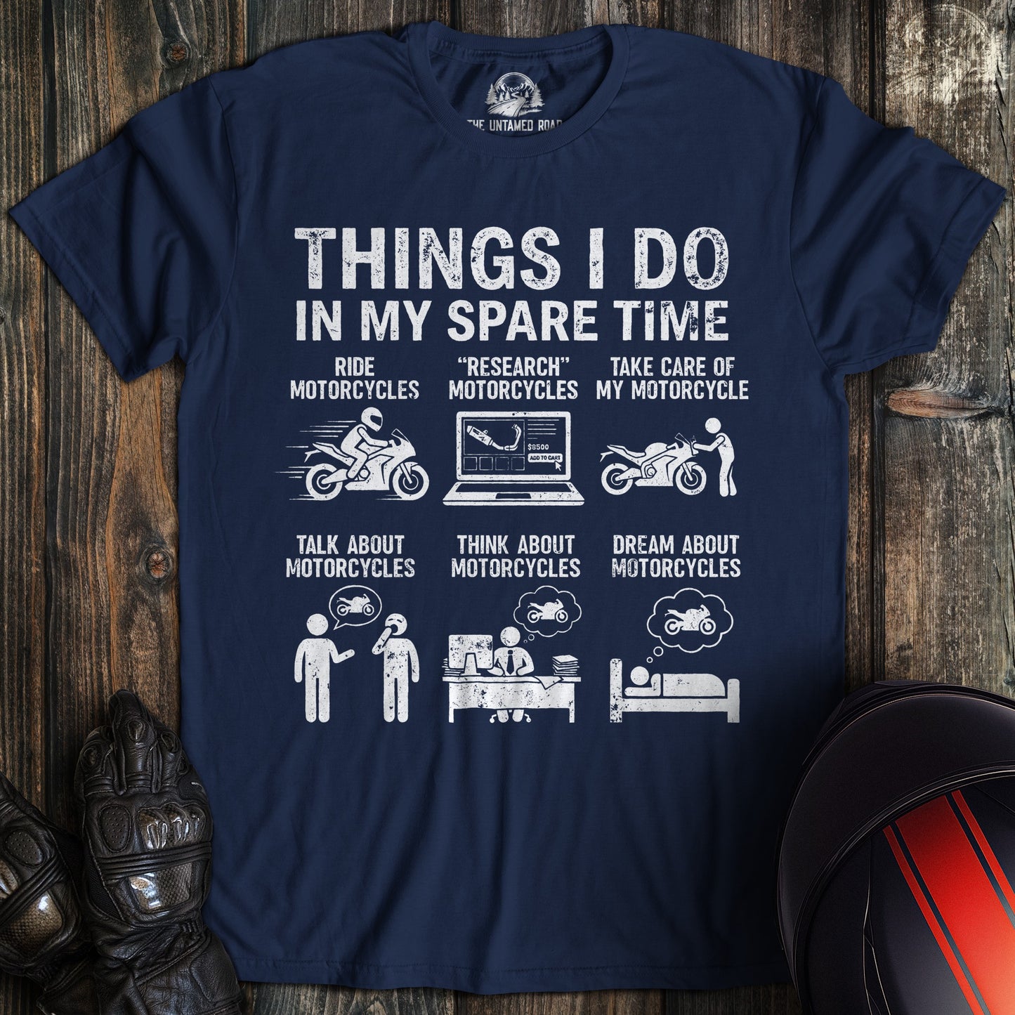 A navy blue t-shirt featuring a funny graphic titled "Things I Do In My Spare Time" with motorcycle-themed illustrations.